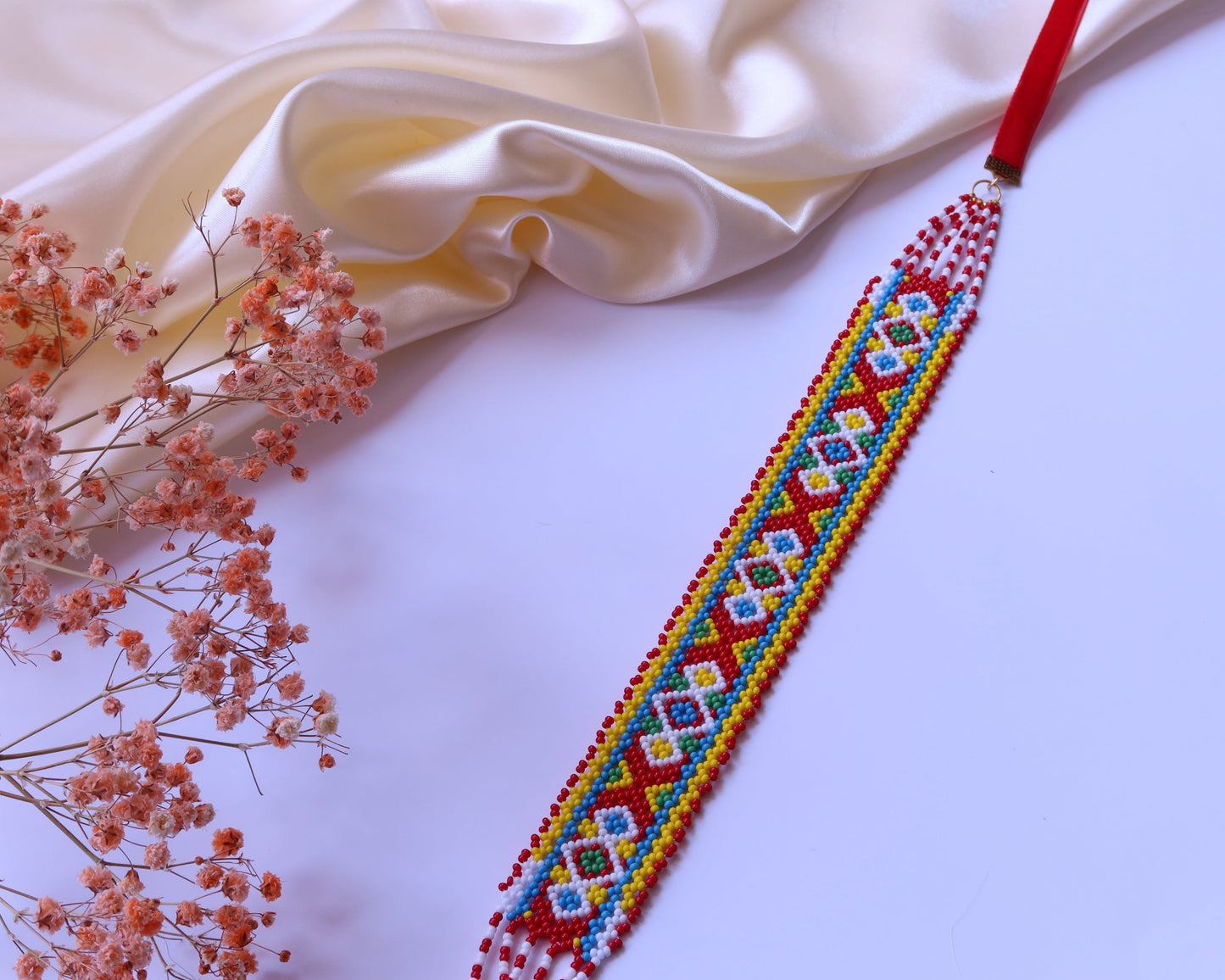 Comely UA Gerdan "Khust Ornament" beaded necklace with red, yellow, blue, and white geometric pattern. Replica of traditional Ukrainian adornment.