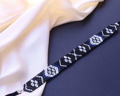 Comely UA Gerdan "Kosach" beaded necklace with black, white, and blue floral and diamond patterns. Replica of Lesia Ukrainka's necklace.