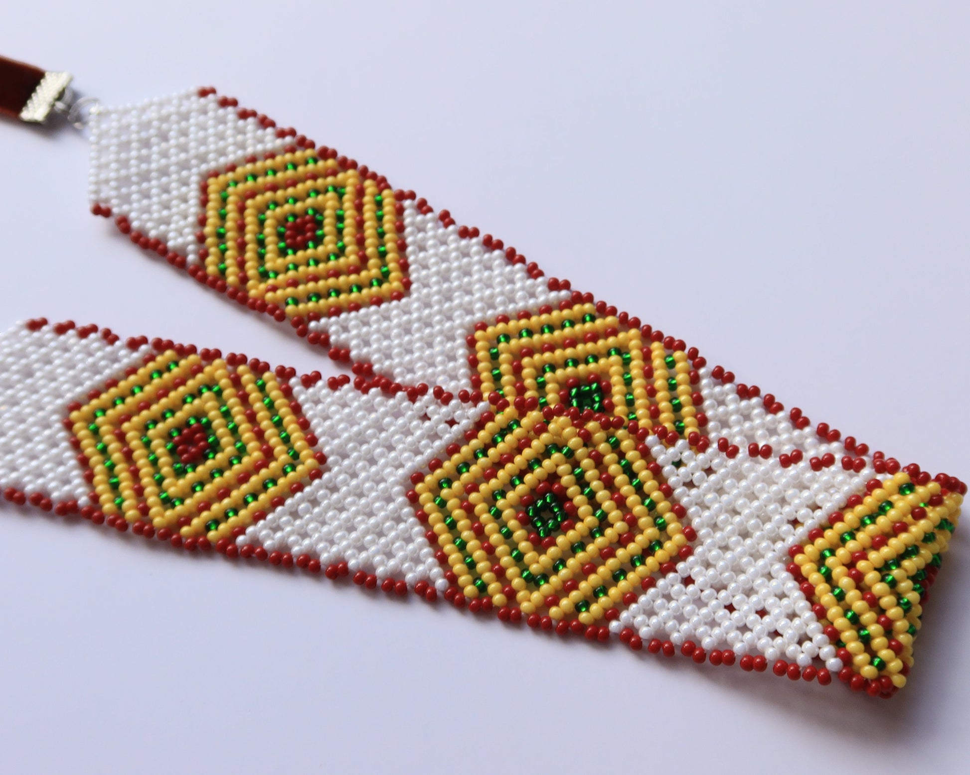 Comely UA white beaded gerdan necklace with yellow, green, and red diamond pattern. Features velvet ribbons for adjustable fit.