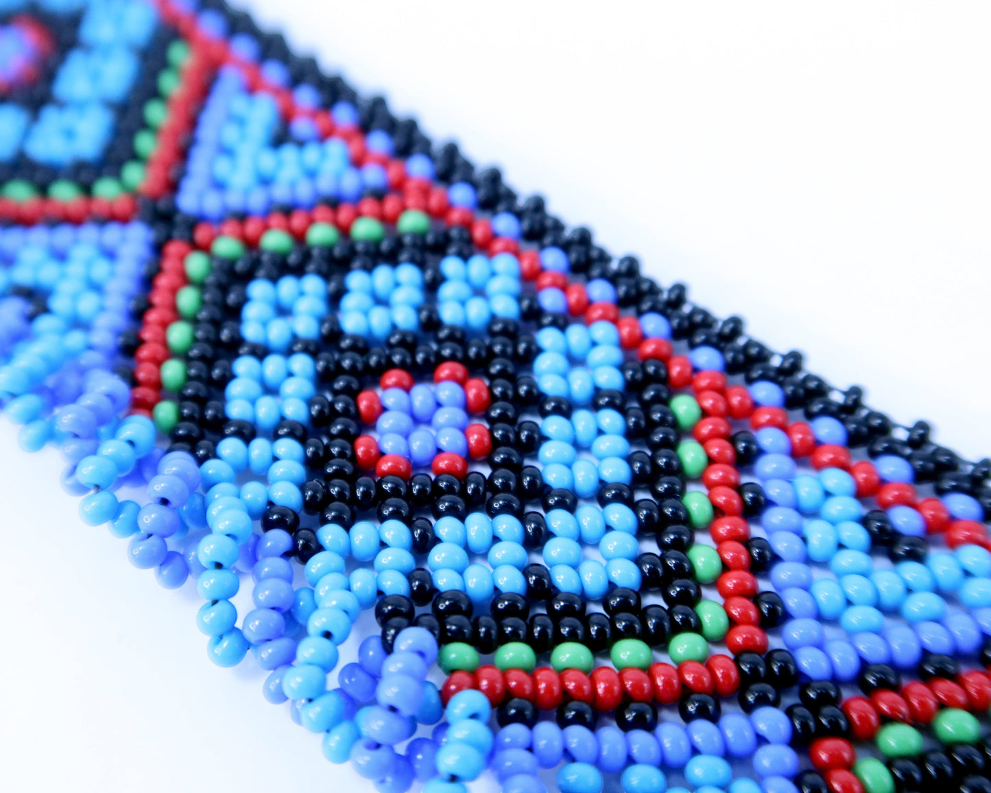 Comely UA Gerdan Luchka beaded necklace with blue, black, red, and green geometric pattern and blue fringe.