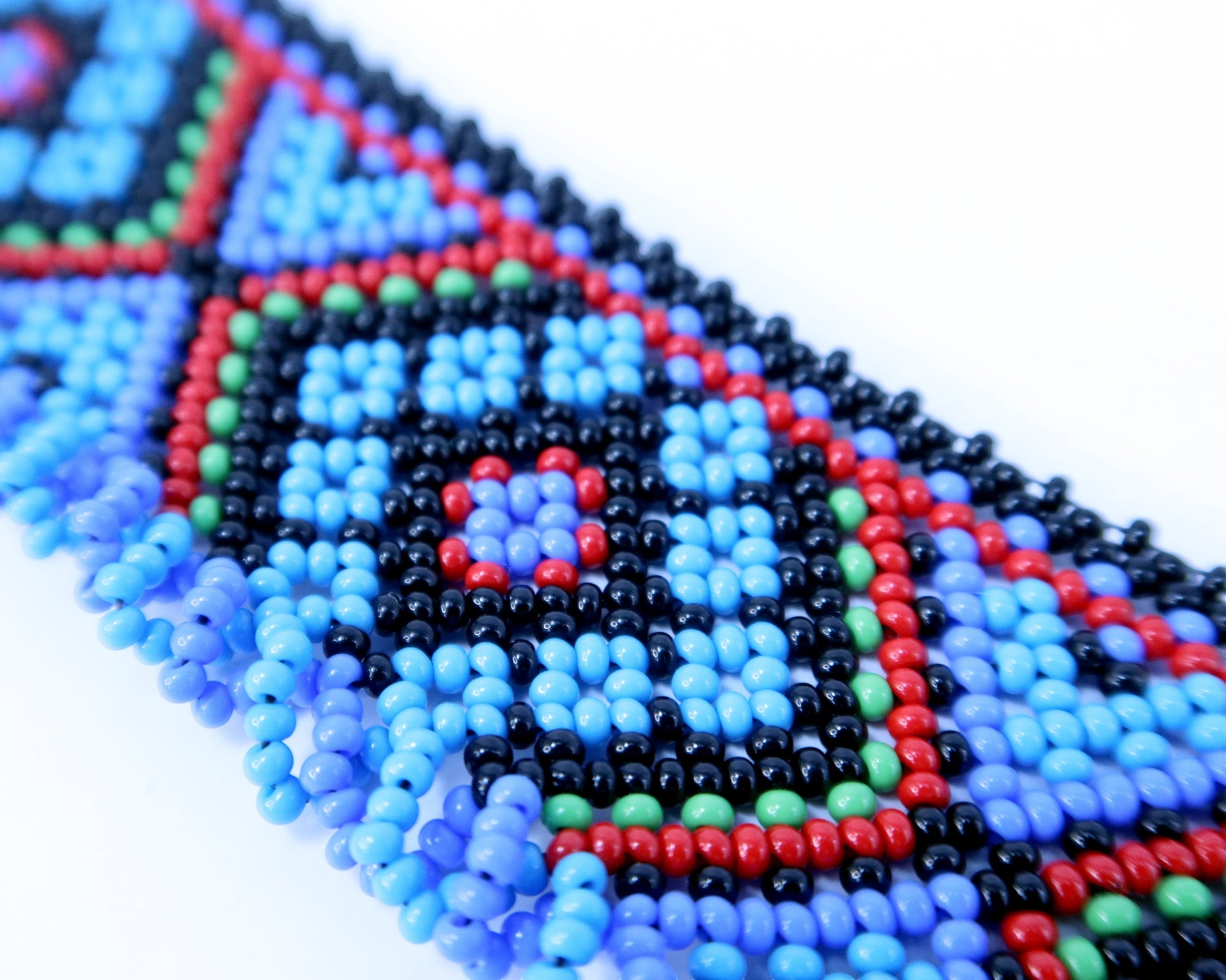 Comely UA Gerdan Luchka beaded necklace with blue, black, red, and green geometric pattern and blue fringe.