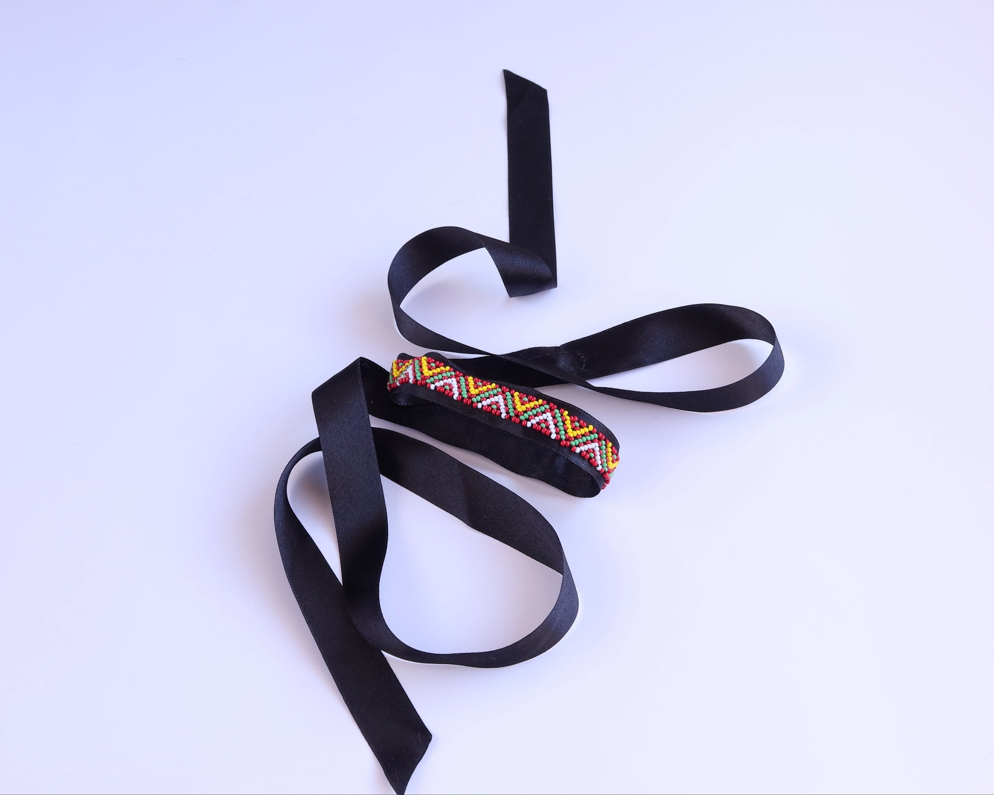 Comely UA Gerdan Three Fires beaded ribbon necklace with red, yellow, green diamond motif on black satin ribbon.