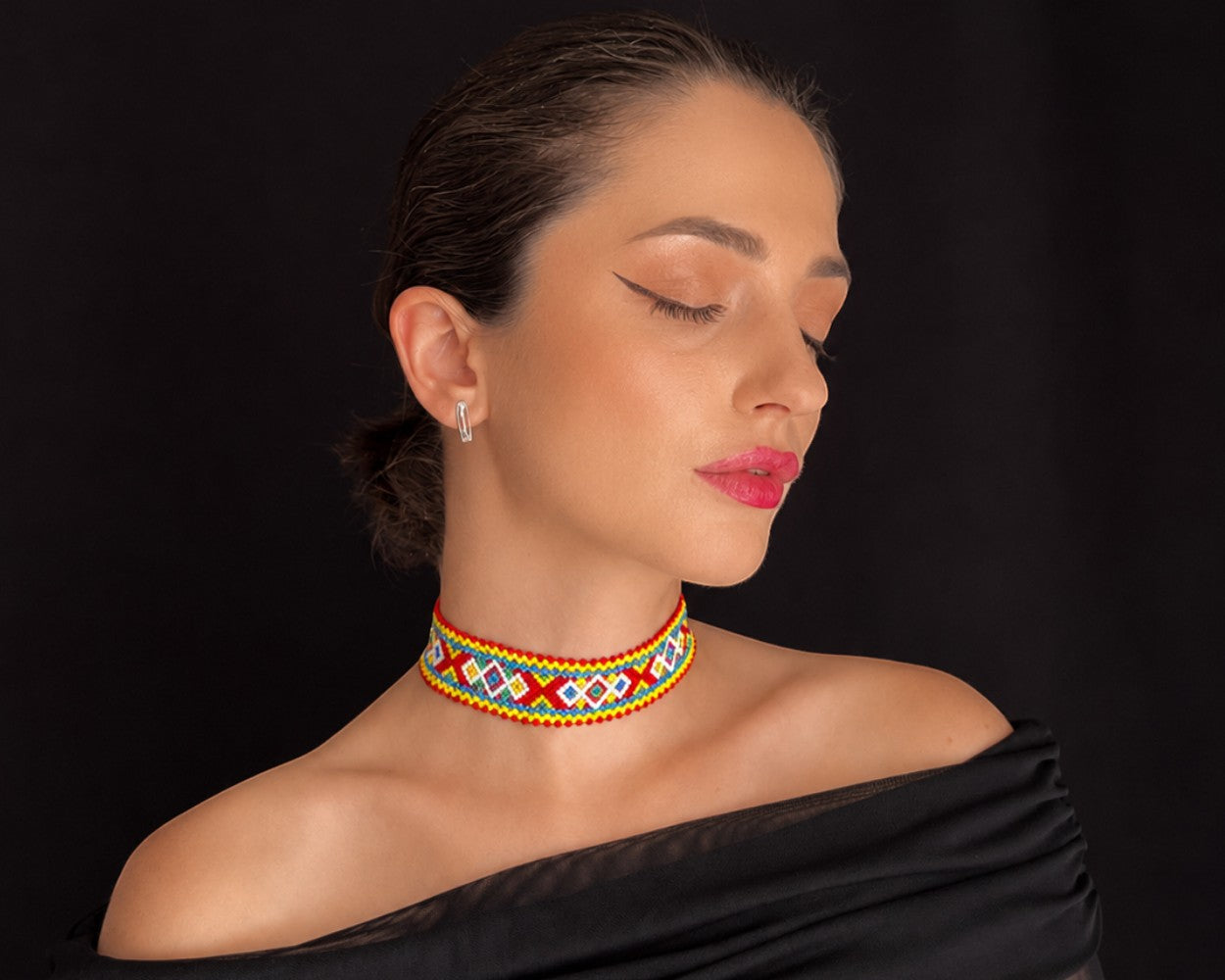 Comely UA Khust Ornament beaded choker necklace with red, yellow, blue, and white geometric diamond pattern. Replica of traditional Ukrainian adornment.