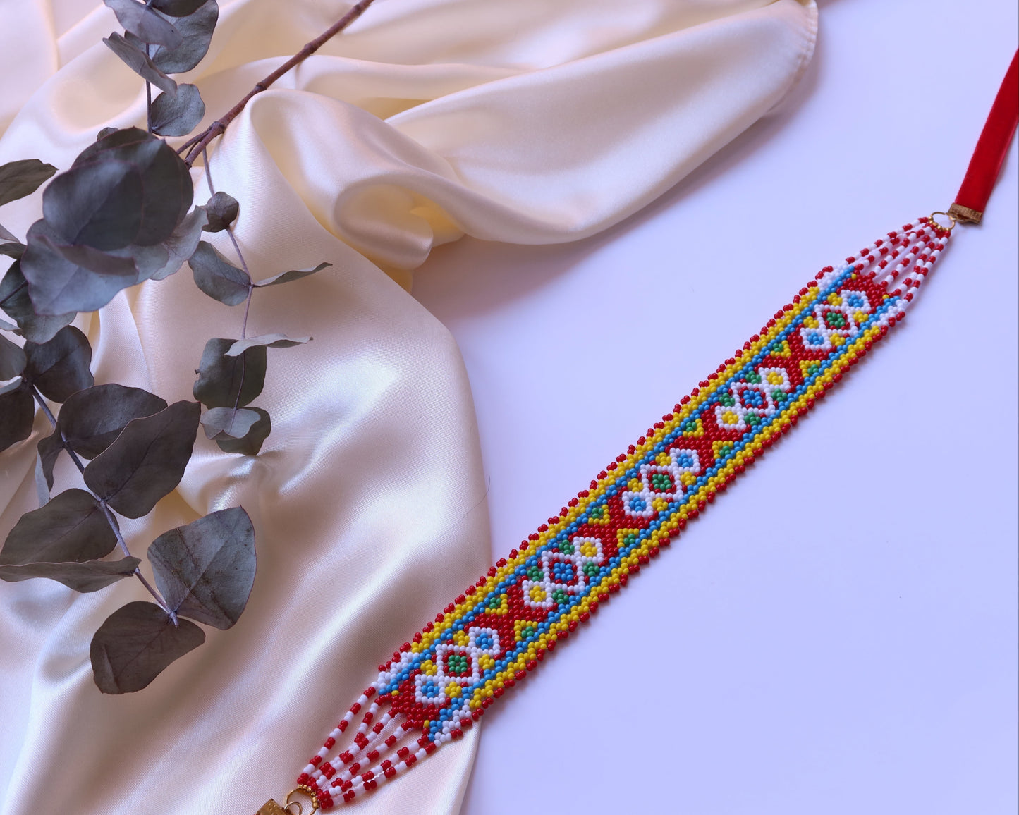 Comely UA Khust Ornament beaded gerdan with red, yellow, blue, and white geometric diamond pattern. Adjustable clasp.