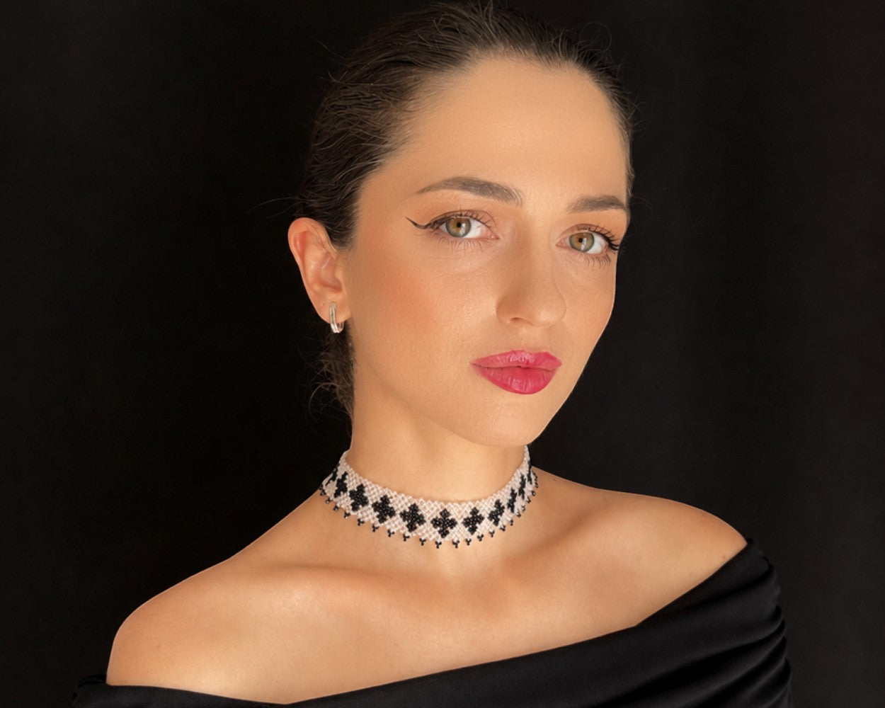 Comely UA Ladana gerdan choker with black cross pattern on transparent base, made of Czech seed beads.