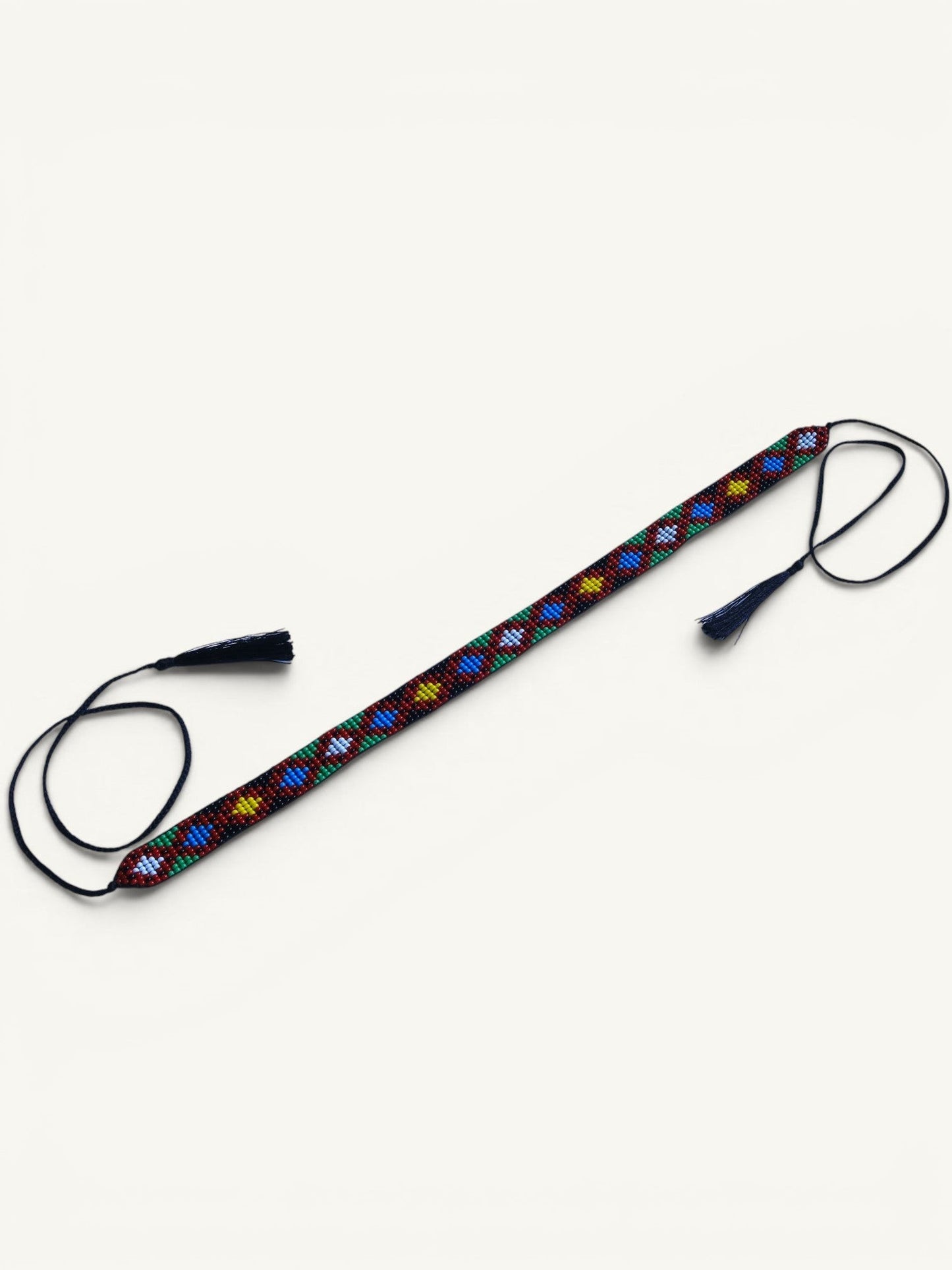 Comely UA Legacy of Time gerdan, a beaded necklace with diamond motifs in red, yellow, blue, green, and white, featuring tassel cords.