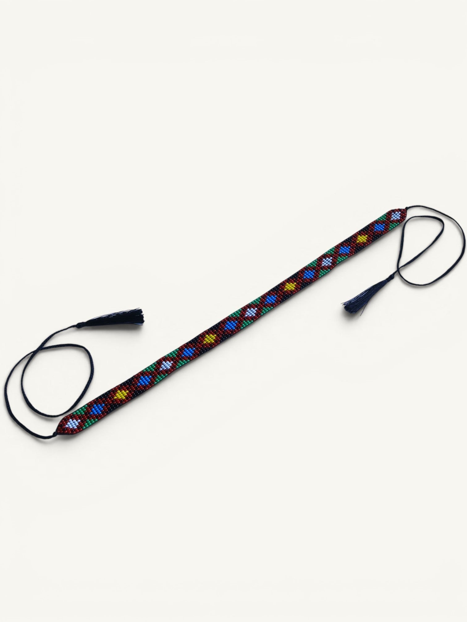 Comely UA Legacy of Time gerdan, a beaded necklace with diamond motifs in red, yellow, blue, green, and white, featuring tassel cords.