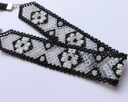 Comely UA Mistweaver beaded gerdan necklace with black, milk, and clear glass beads in a geometric pattern.