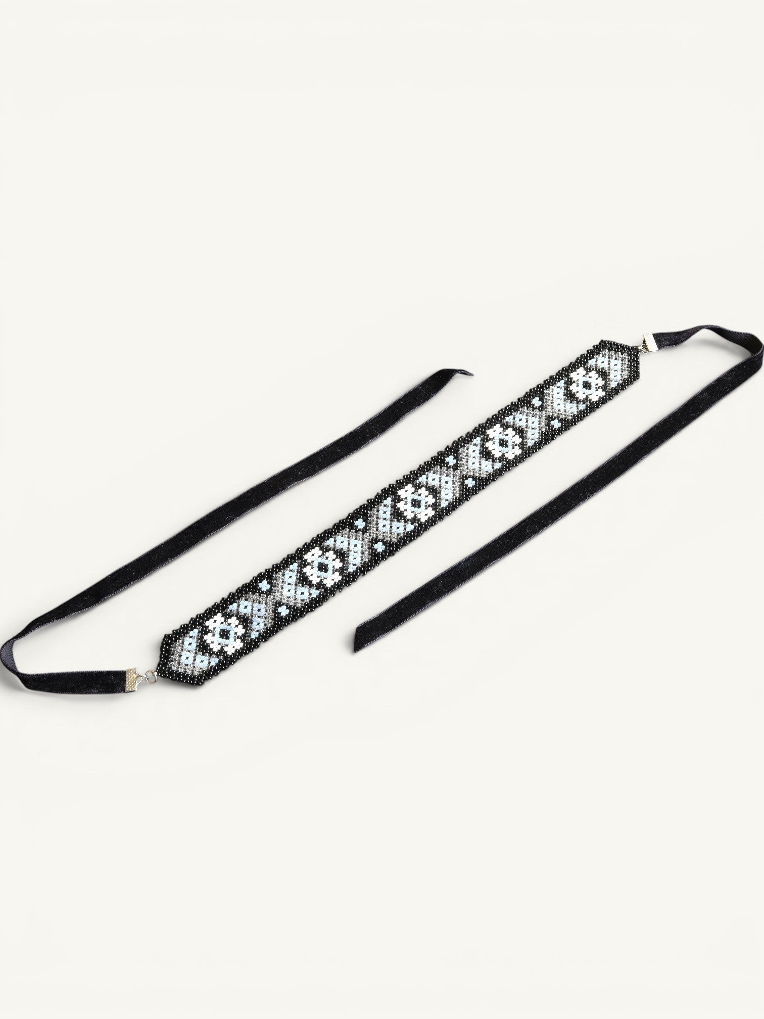 Comely UA Mistweaver beaded gerdan necklace with black, milk, and clear glass beads in a geometric pattern, on black velvet ribbons.