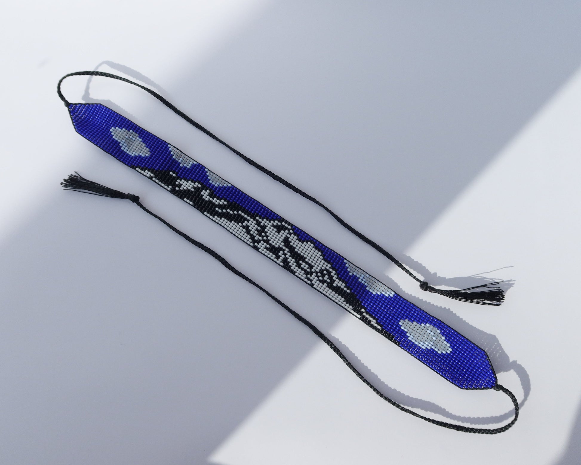 Comely UA blue, white, and black beaded gerdan necklace with Mont Blanc mountain pattern and tassels.