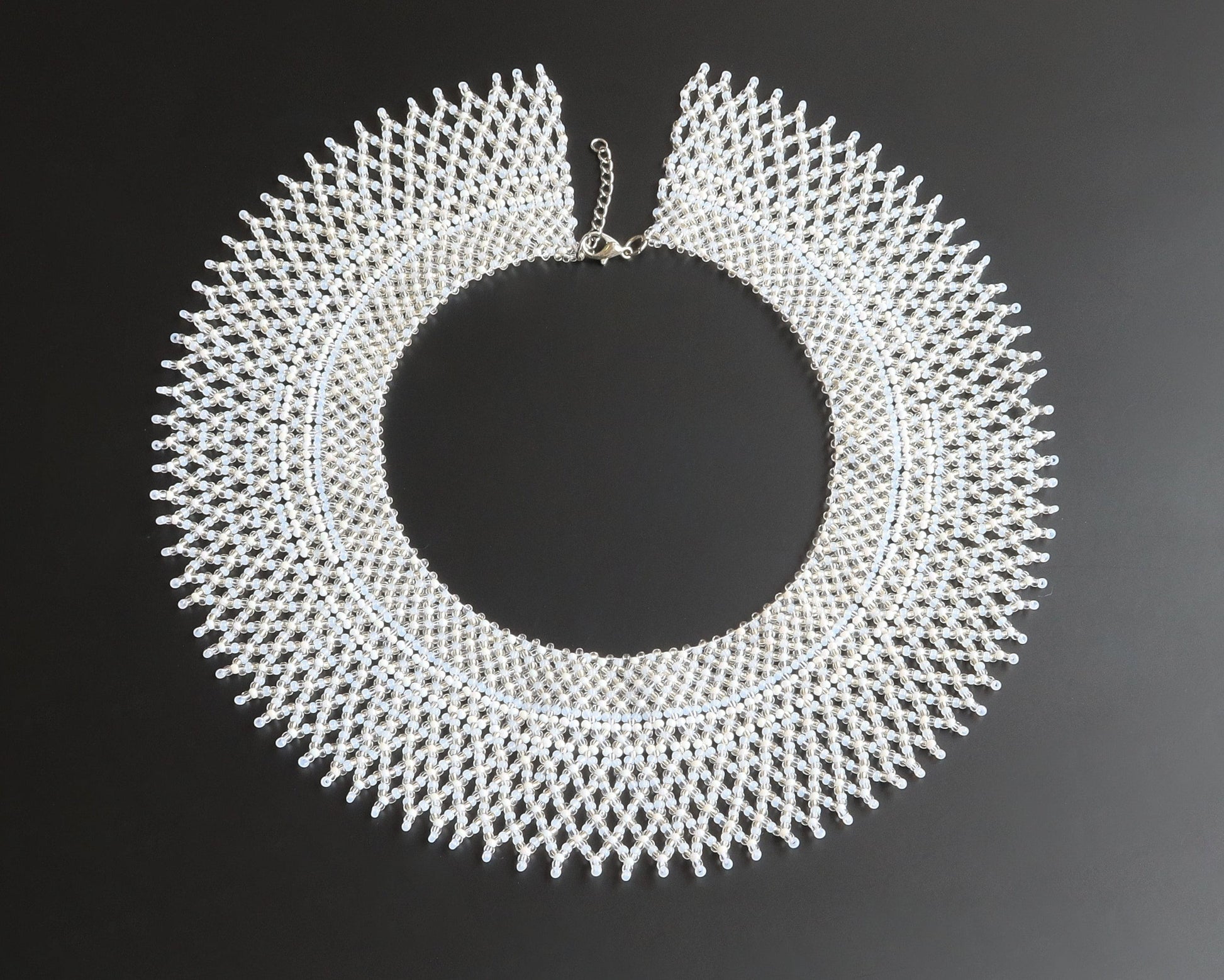 Comely UA "Moonlit Dew" beaded silyanka necklace in white, transparent, milky, and silver shades. Circular design with intricate beadwork.