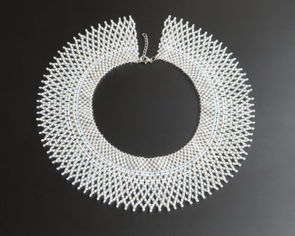 Comely UA "Moonlit Dew" beaded silyanka necklace in white, transparent, milky, and silver shades. Circular design with intricate beadwork.