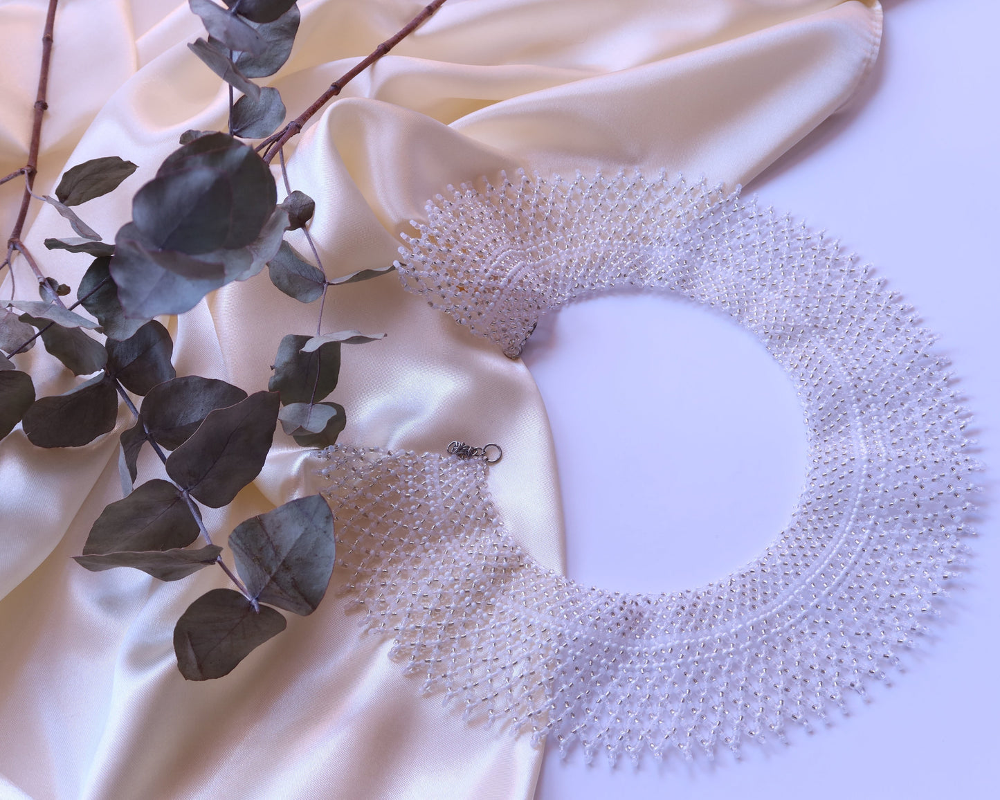 Comely UA "Moonlit Dew" beaded silyanka necklace in white, silver, and transparent Czech seed beads. Circular design.