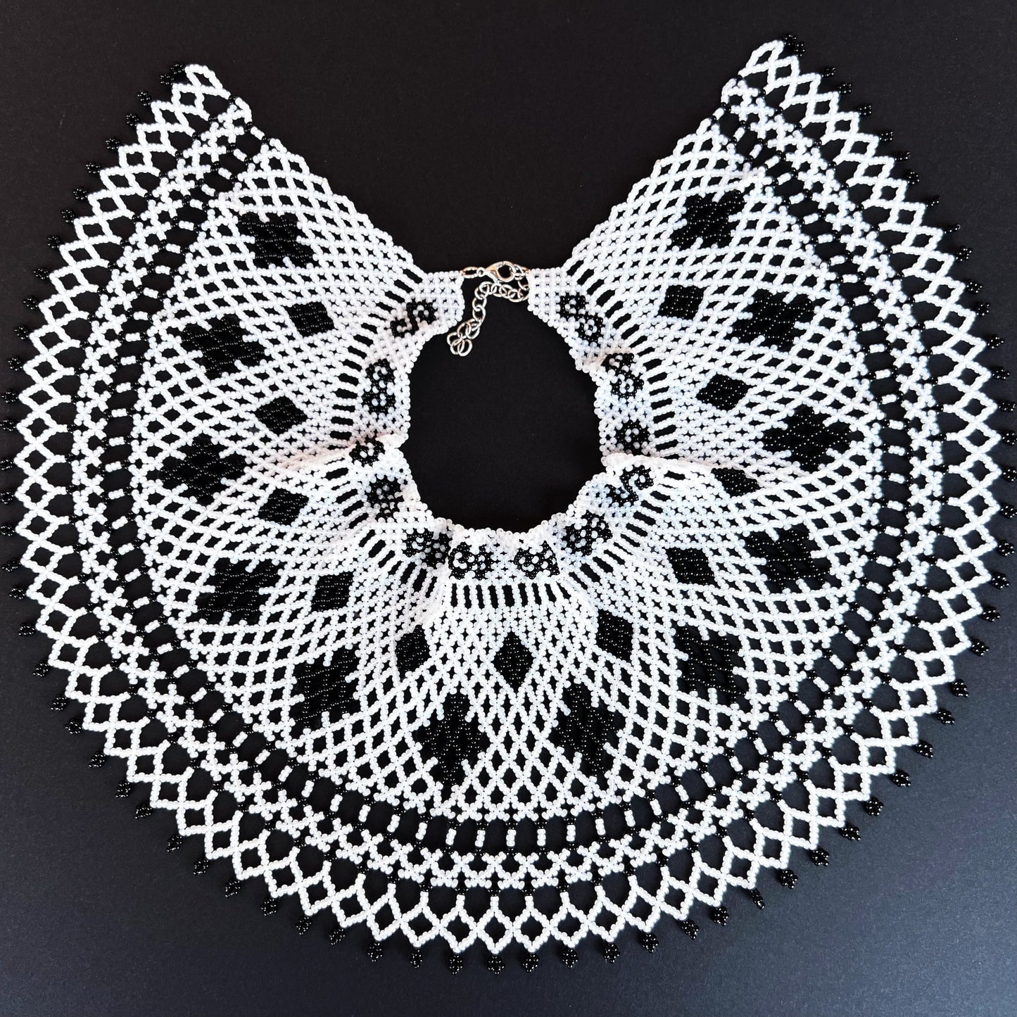 Comely UA "Primla" beaded necklace, black and white Czech seed beads, circular design with diamond and cross motifs.
