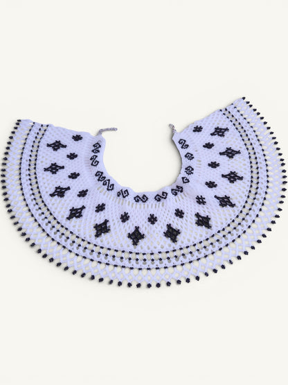 Comely UA Primla beaded necklace in black and white, featuring diamond and cross symbols, with a net-like structure and adjustable clasp.
