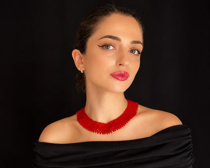 Comely UA red beaded silyanka necklace, a traditional Ukrainian choker with a modern design, worn by a model against a black background.