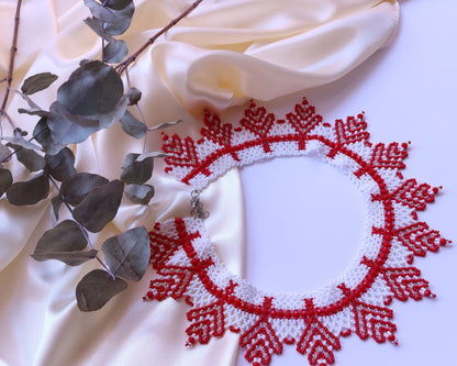 Comely UA white and red beaded necklace with a jagged sunray design, made from Czech seed beads.