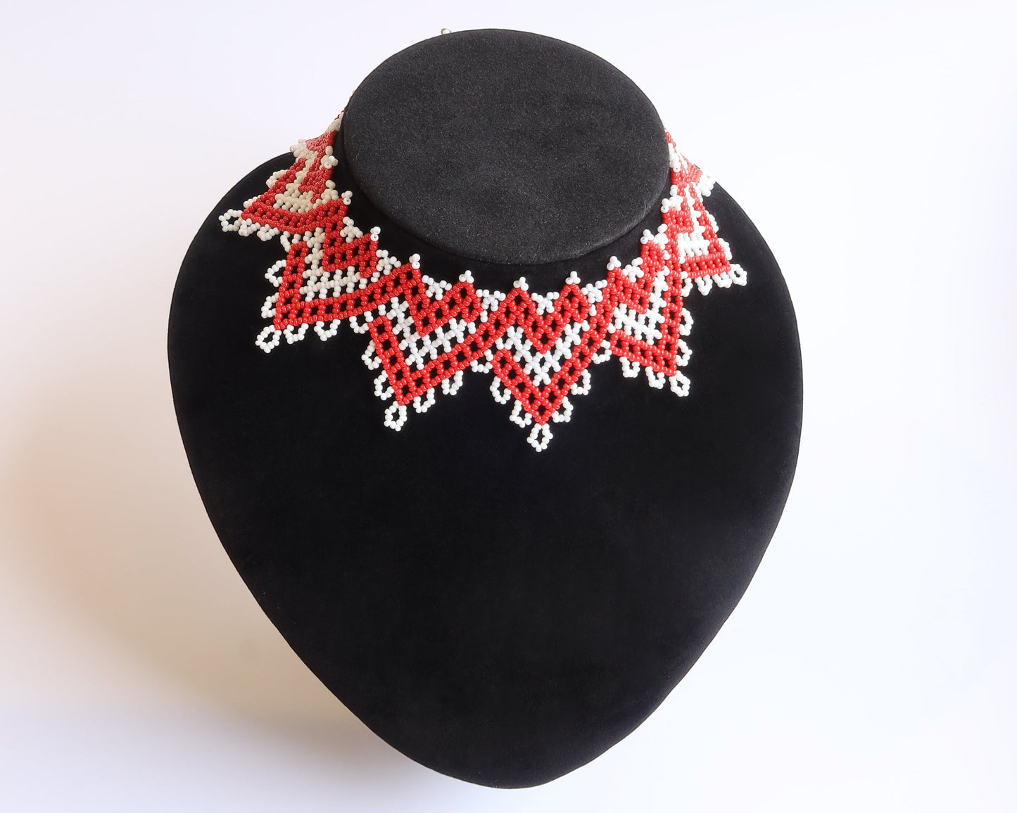 Comely UA red and white beaded zigzag silyanka necklace with velvet ribbon ties, inspired by winter sun symbolism.