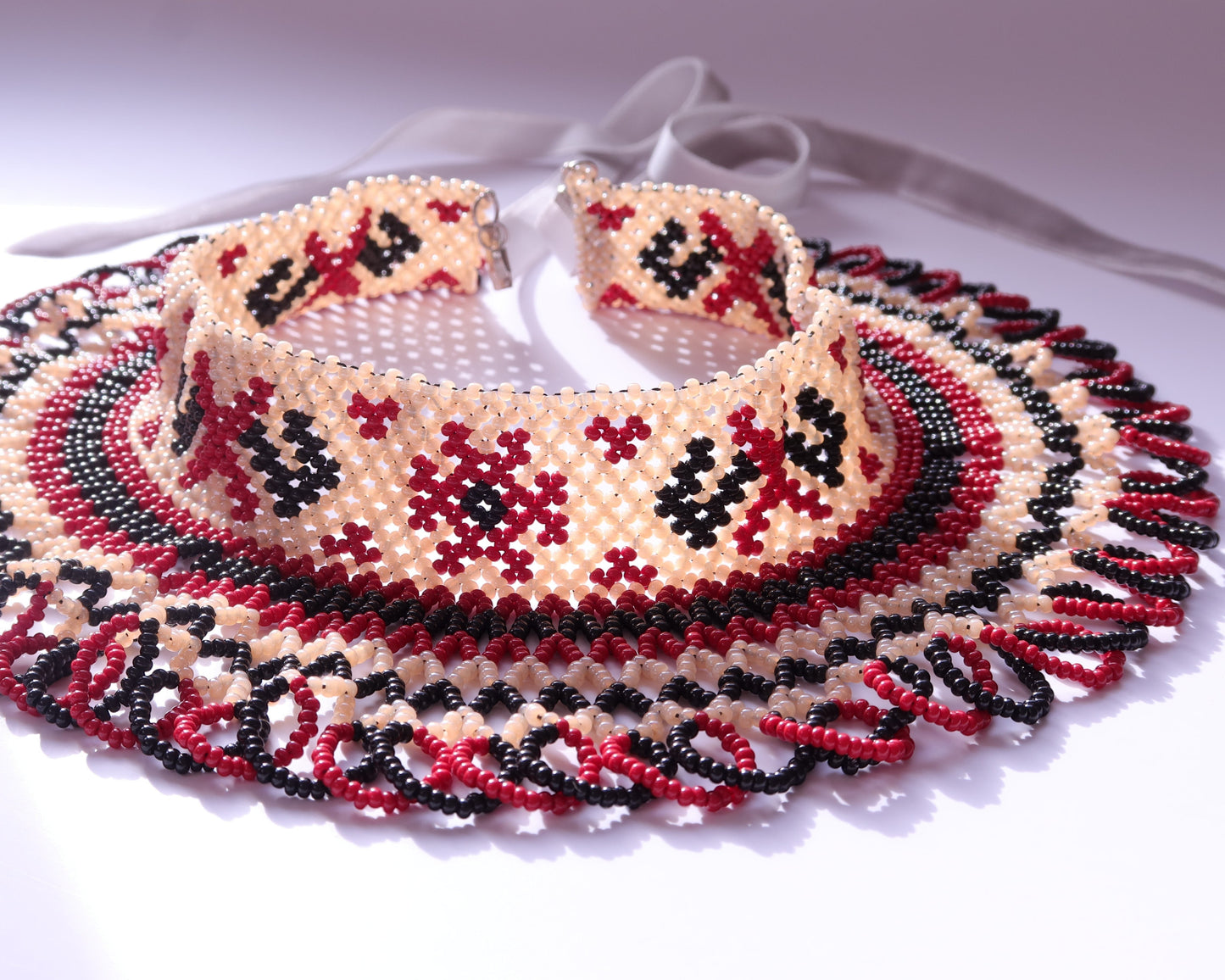 Comely UA traditional silyanka beaded necklace with cream, red, and black diamond and cross motifs. Features intricate edging and velvet ties.
