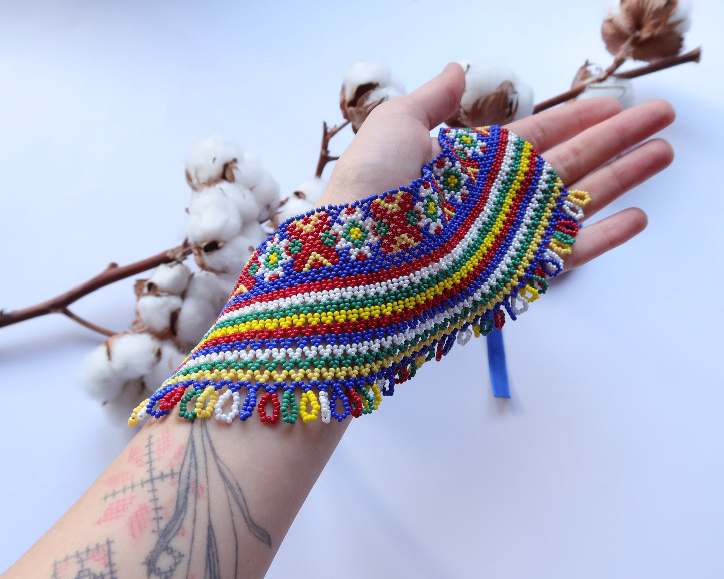 Comely UA two-part silyanka beaded necklace with red, yellow, blue, green, and white beads. Features solar and floral motifs.