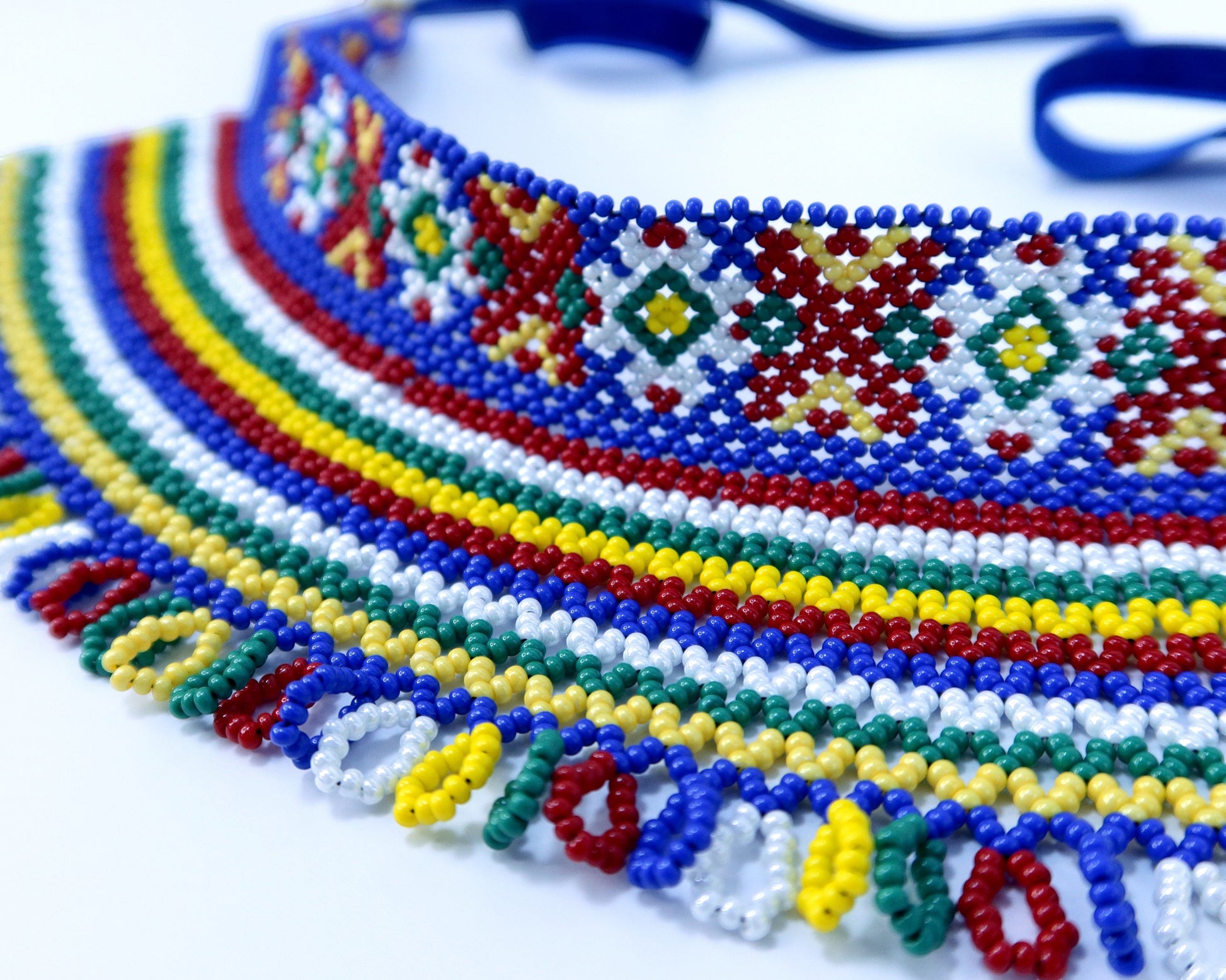 Comely UA two-part silyanka beaded necklace with red, yellow, green, white, and blue beads. Features solar and floral motifs.