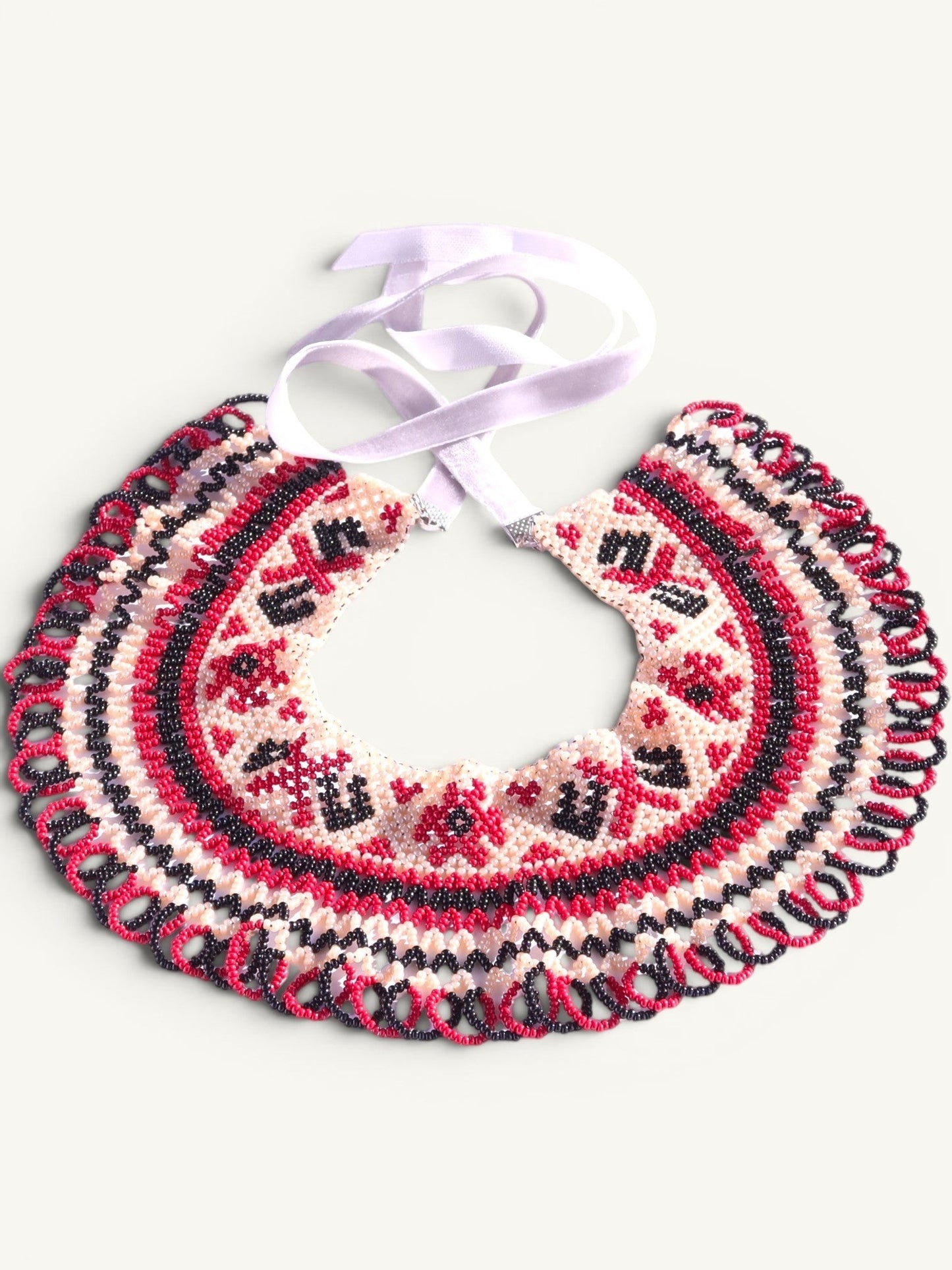 Comely UA Silyanka "Heritage of Pokuttia" beaded collar necklace with red, black, and cream diamond and cross motifs. Features velvet ties.