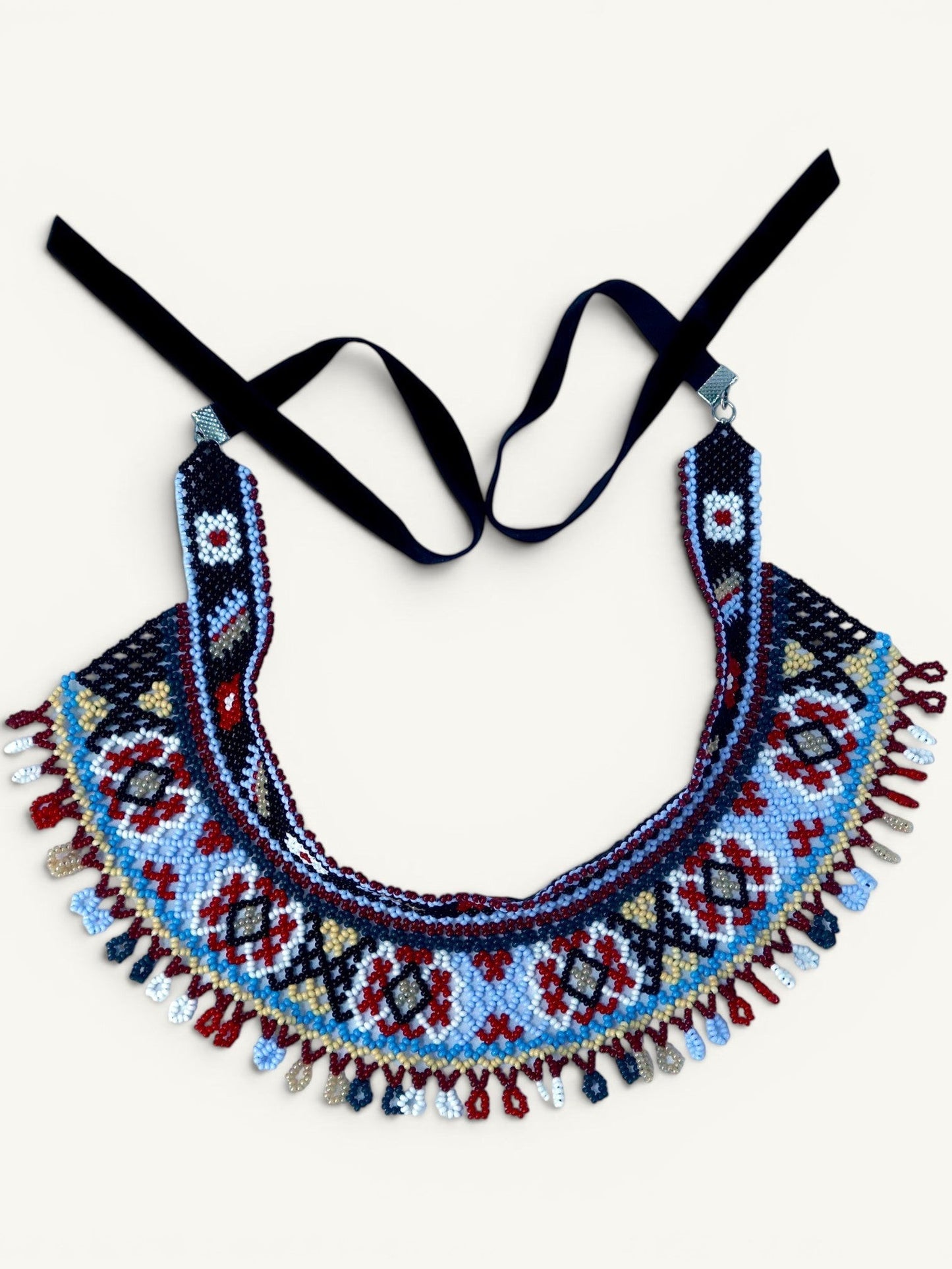 Comely UA Two-part Silyanka Ladder beaded necklace with black velvet ribbons, featuring geometric patterns in red, blue, white, and yellow.