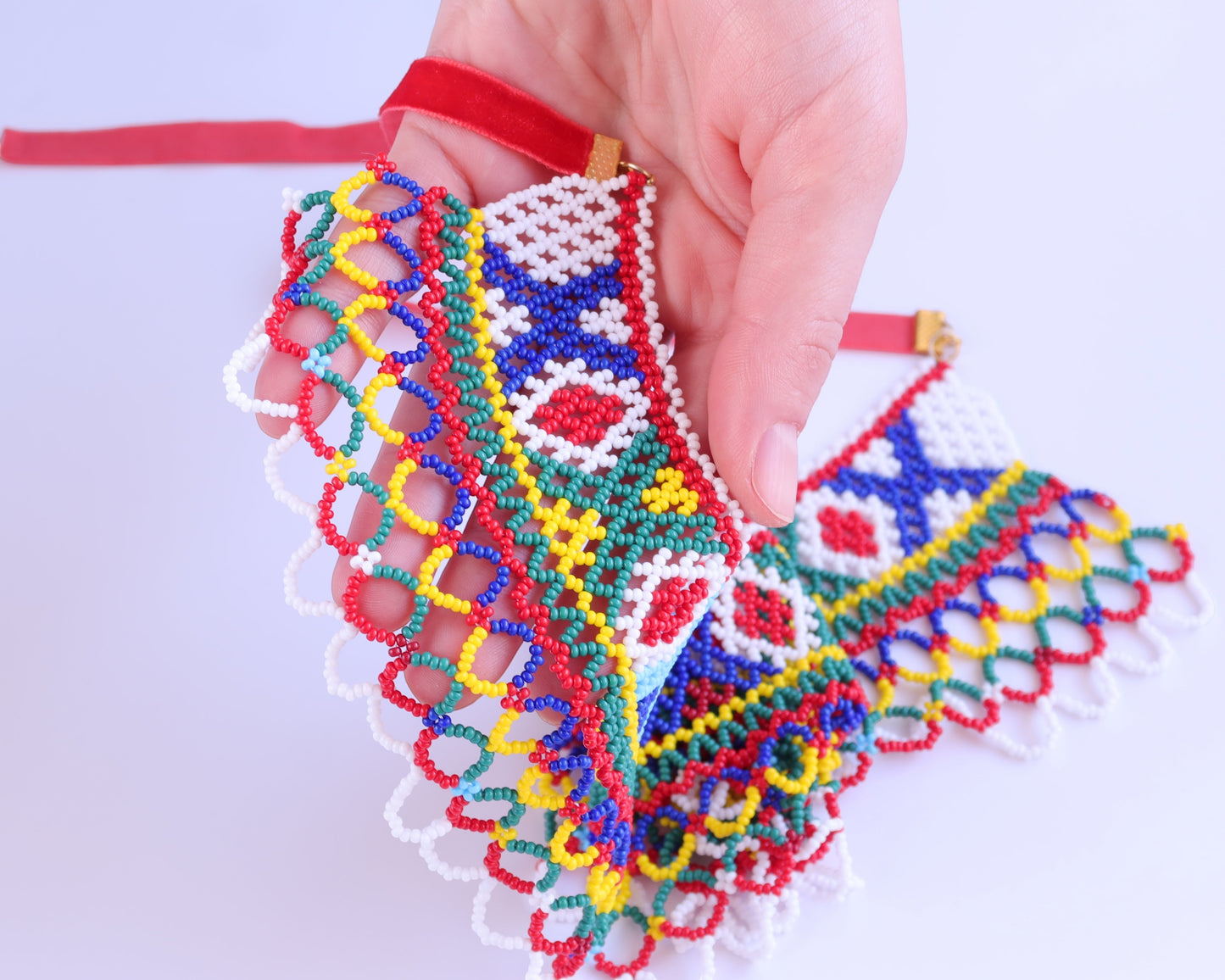 Comely UA Silyanka Lado beaded necklace replica with red velvet ties, featuring diamond and cross motifs in blue, red, green, and yellow.
