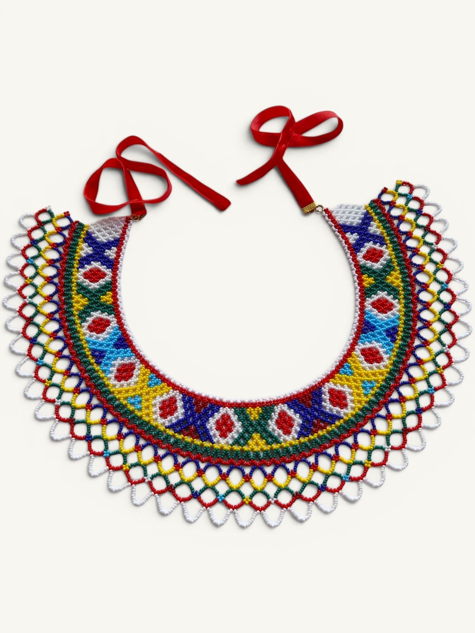 Comely UA Silyanka Lado beaded necklace with diamond and cross motifs in red, blue, yellow, green, and white. Features red velvet ties.