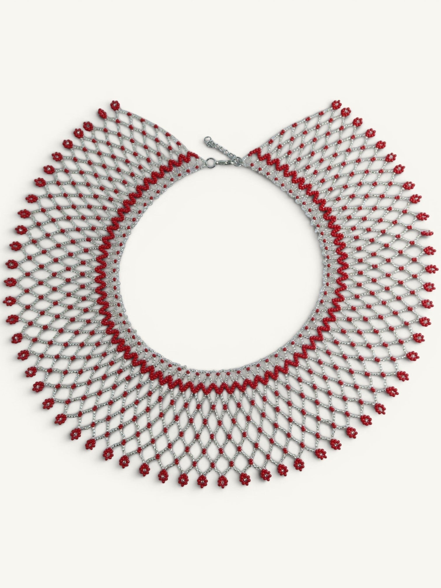 Comely UA Silyanka Solar Crown necklace with red floral bead accents on a silver net pattern. Adjustable clasp.