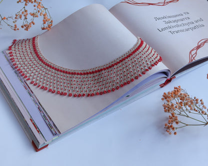 Comely UA Silyanka Solar Crown beaded necklace with red floral elements on a silver web. Czech seed beads.