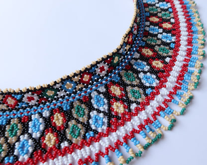 Comely UA two-part beaded necklace with traditional Ukrainian pattern in red, black, blue, green, white, and cream Czech seed beads.