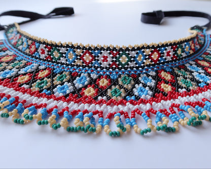 Comely UA two-part beaded necklace with red, black, blue, green, white, and cream Czech seed beads in a net-like structure with diamond motifs.