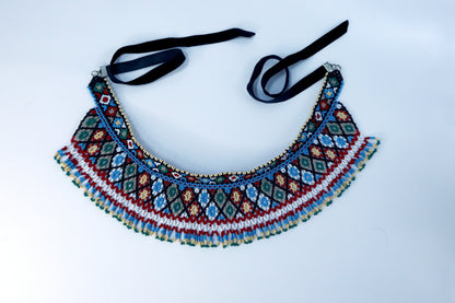 Comely UA two-part beaded necklace with red, blue, green, white, and tan diamond patterns and fringe. Czech seed beads on nylon thread with velvet ribbons.