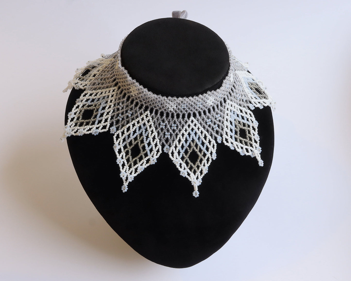 Comely UA white and silver beaded lace-like choker necklace with diamond motifs and floral ends.