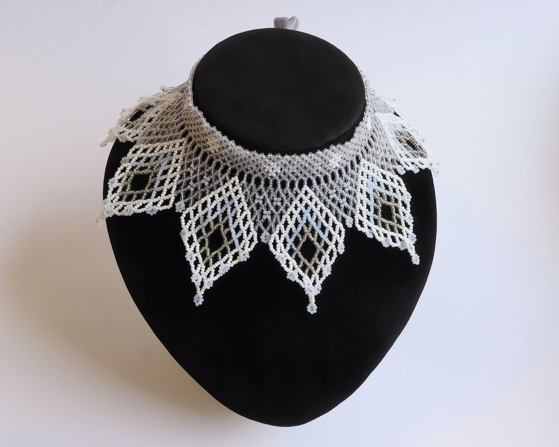 Comely UA white and silver beaded lace-like choker necklace with diamond motifs and floral ends.