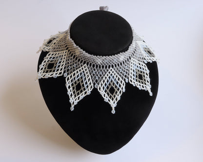 Comely UA white and silver beaded lace-like choker necklace with diamond motifs and floral ends.