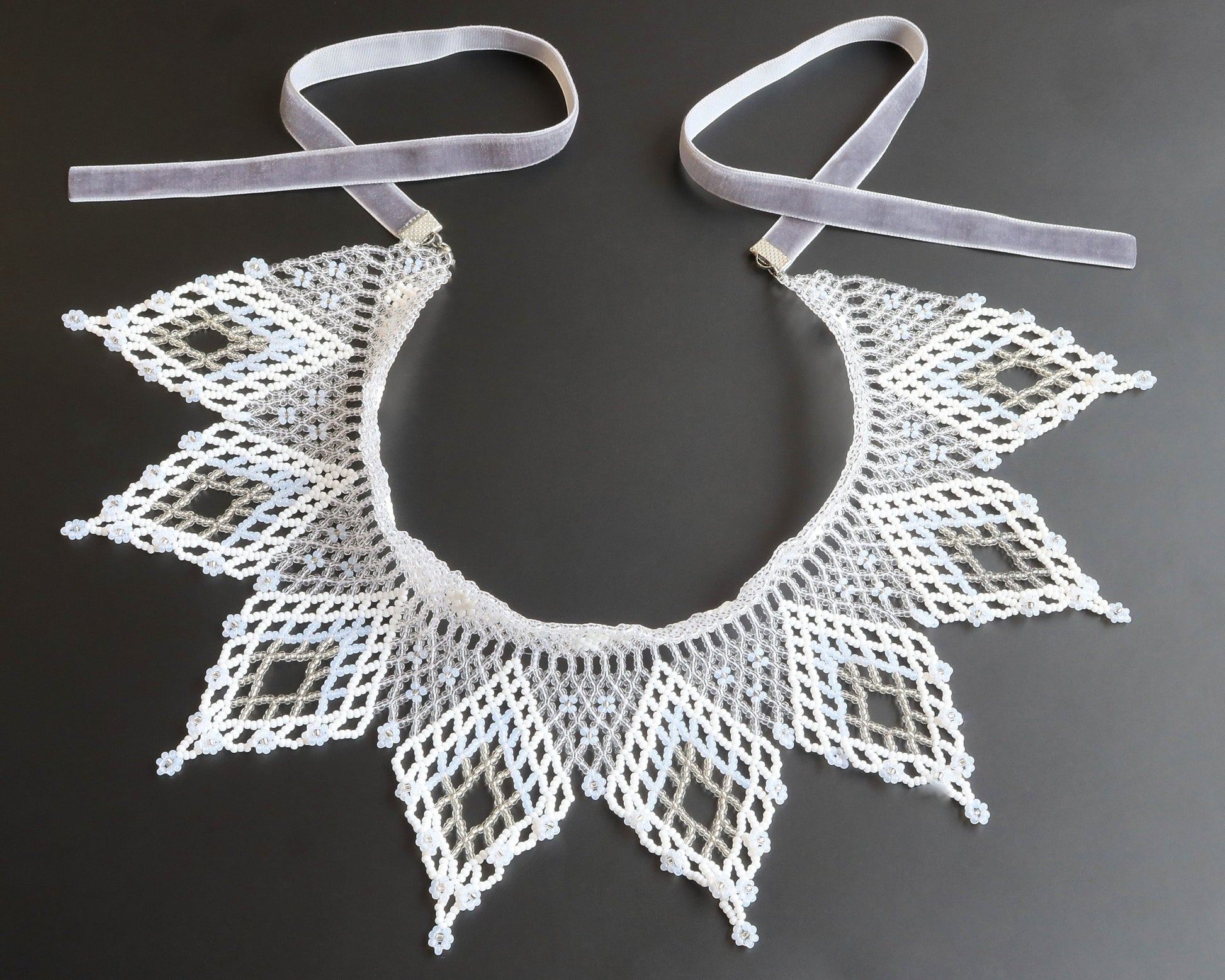 Comely UA white and silver beaded lace collar necklace with diamond motifs and floral ends, velvet ribbon ties.