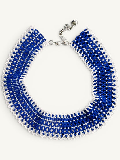 Comely UA "Winter River" beaded choker necklace in blue and white with adjustable clasp. Features intricate linear pattern.