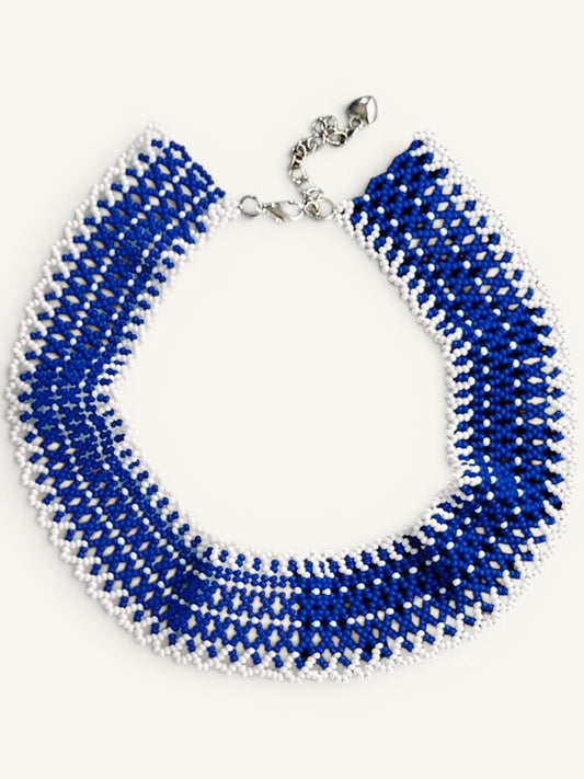 Comely UA "Winter River" beaded choker necklace in blue and white with adjustable clasp. Features intricate linear pattern.