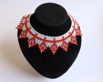Comely UA "Zakhrava" beaded necklace in red and white Czech seed beads with a jagged sunray edge. Adjustable clasp.