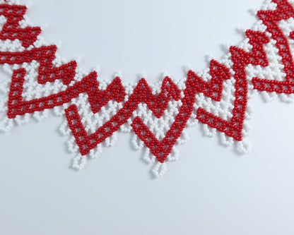 Comely UA red and white zigzag beaded silyanka necklace with velvet ribbon ties. Symbolizes warmth and renewal.