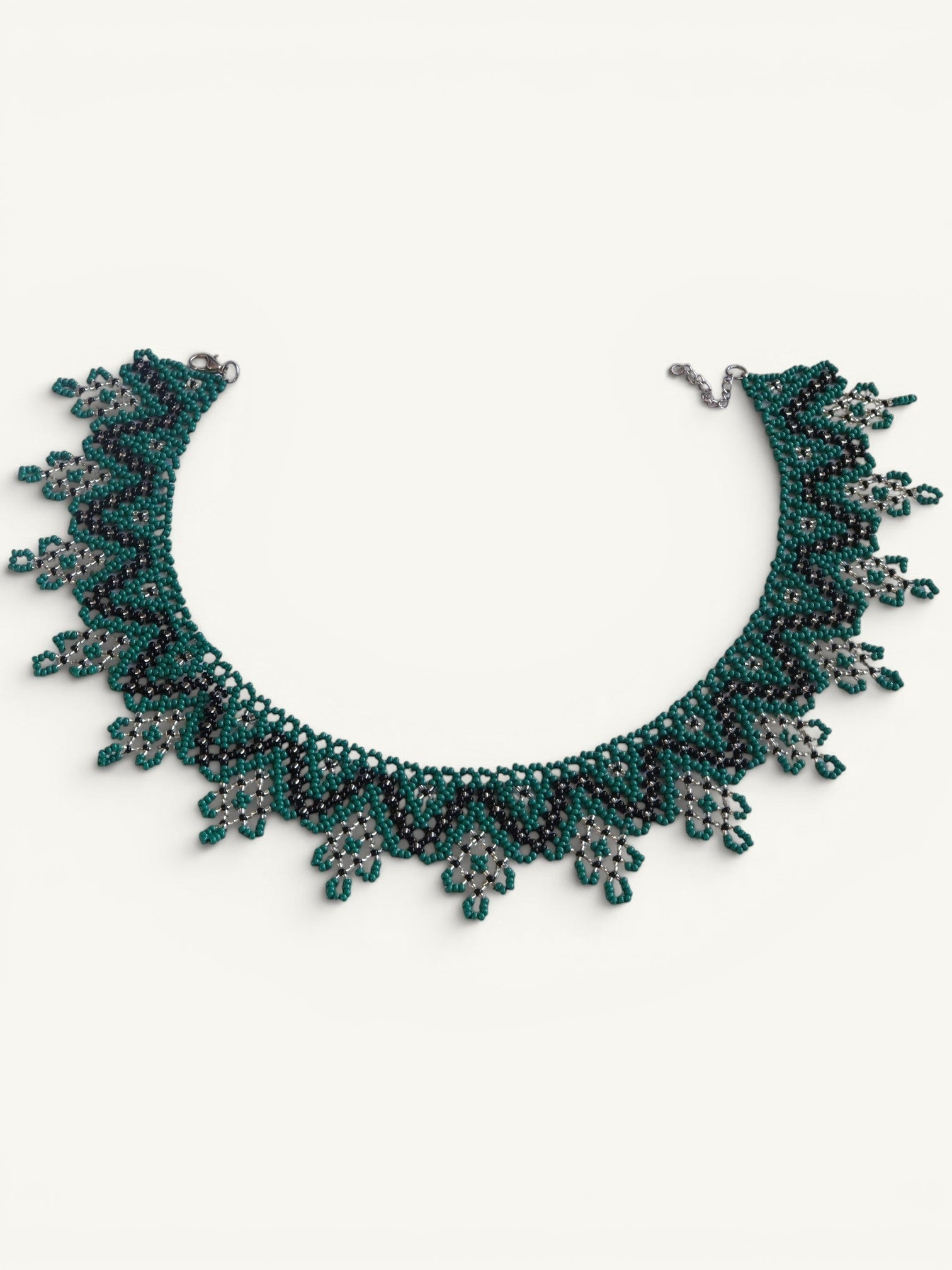 Comely UA Zorianytsia beaded necklace in deep green, black, and yellow with a jagged, wave-like pattern.