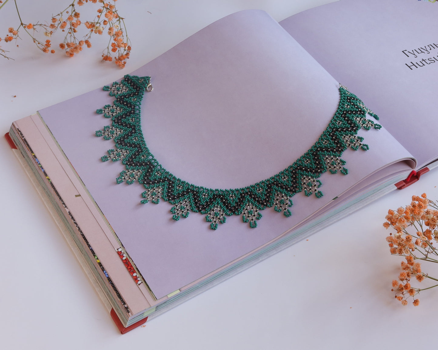 Comely UA Zorianytsia beaded necklace in deep green, black, and yellow. Flat silyanka style with jagged pattern.