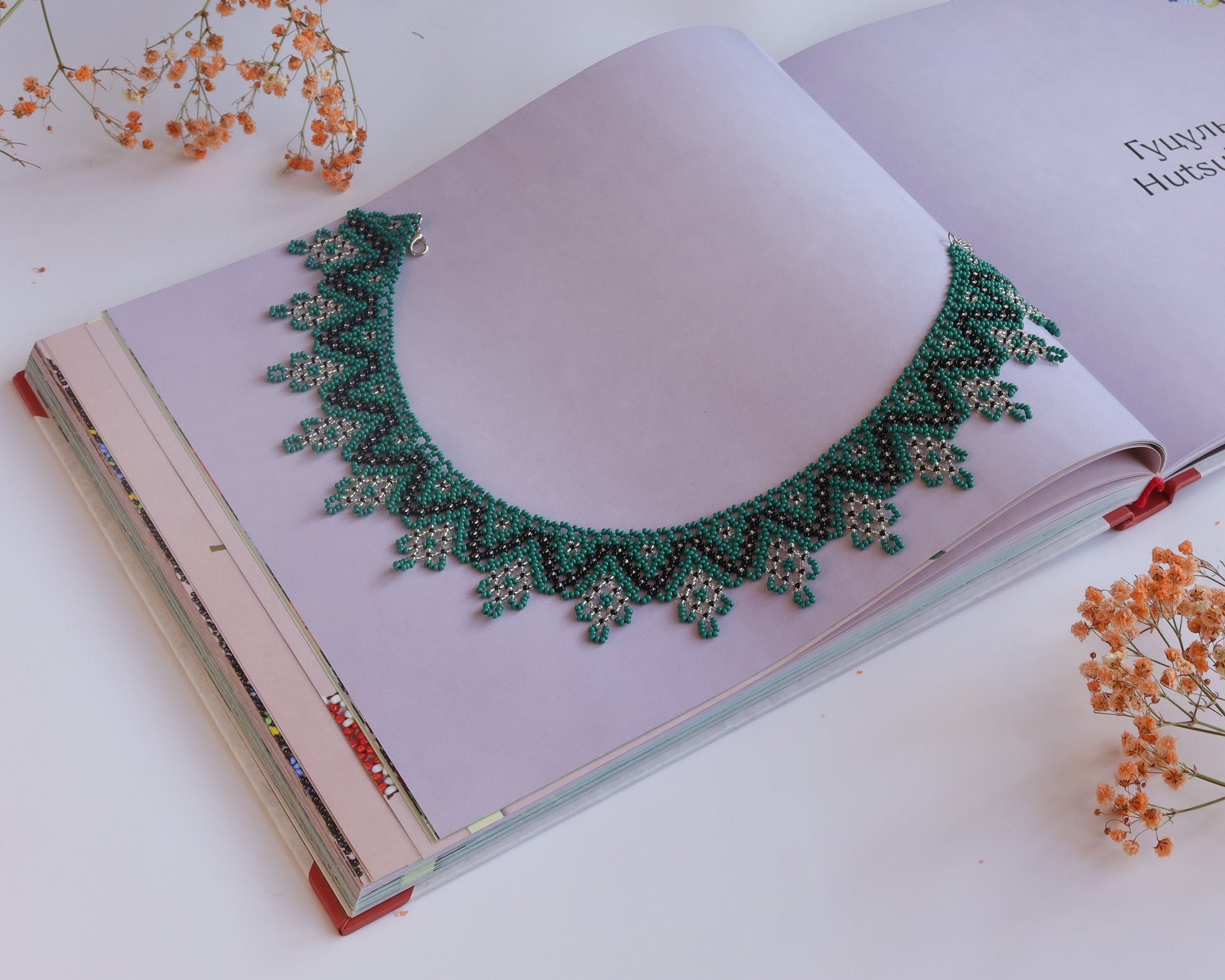 Comely UA Zorianytsia beaded necklace in deep green, black, and yellow. Flat silyanka style with jagged pattern.
