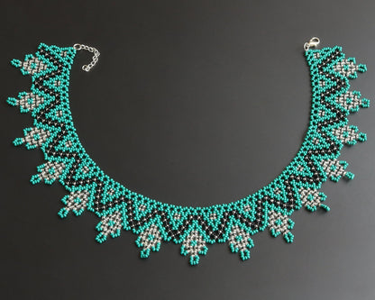 Comely UA Zorianytsia beaded necklace in teal, black, and silver with a jagged pattern. Czech seed beads.