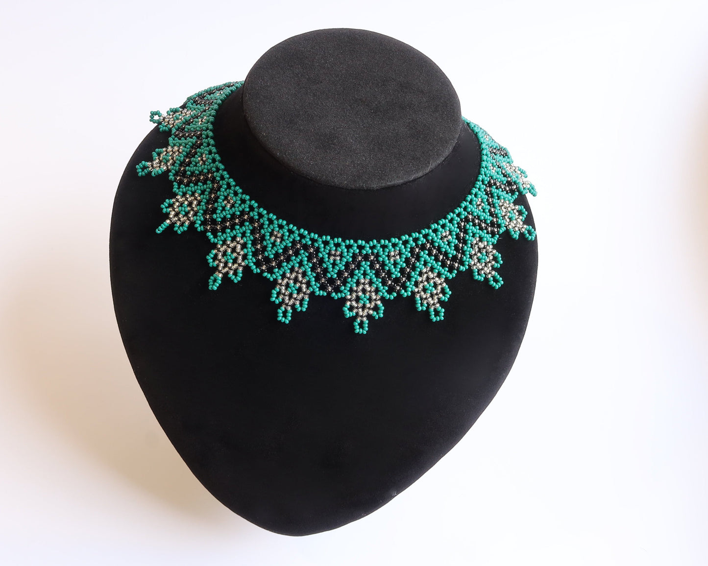 Comely UA Zorianytsia beaded necklace in teal, black, and silver with a jagged pattern. Traditional silyanka style.