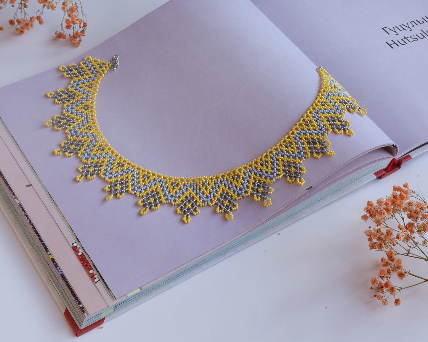 Comely UA "Zorianytsia" beaded necklace in yellow, sky blue, and silver with a jagged wave pattern. Czech seed beads.
