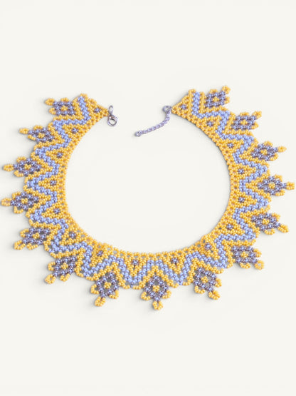 Comely UA "Zorianytsia" beaded necklace in yellow, sky blue, and silver with a jagged wave pattern. Adjustable clasp.