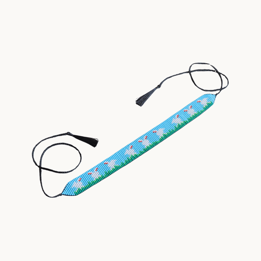 Blue strap with flamingo pattern on a white background